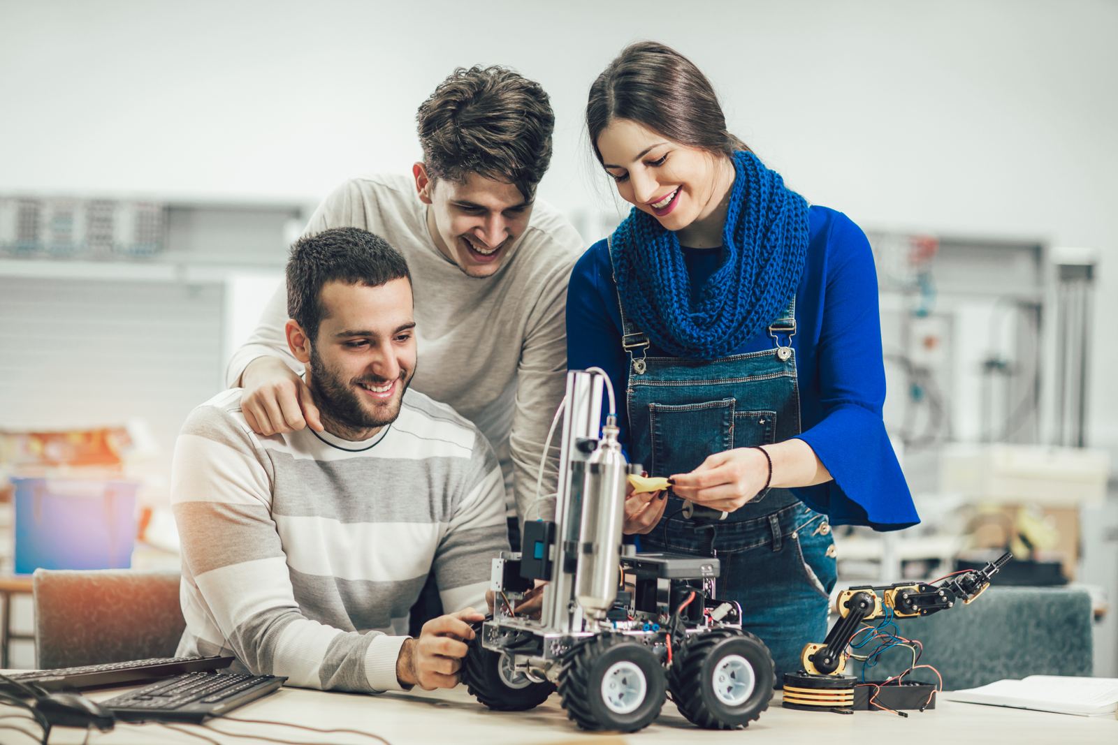 Teacher and students building a robotics project